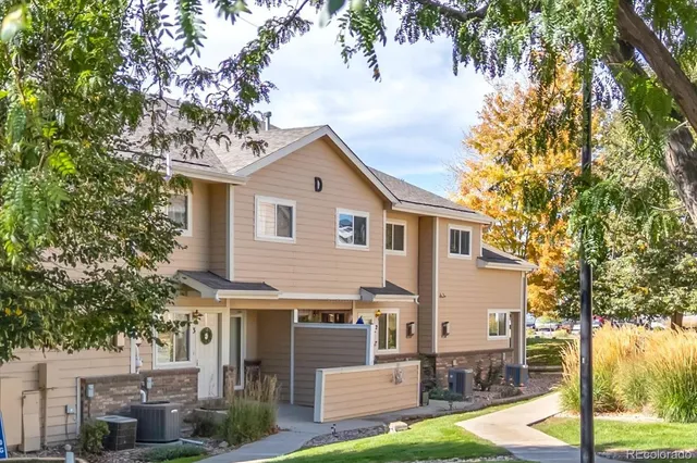 a view of a house with a tree in front of it