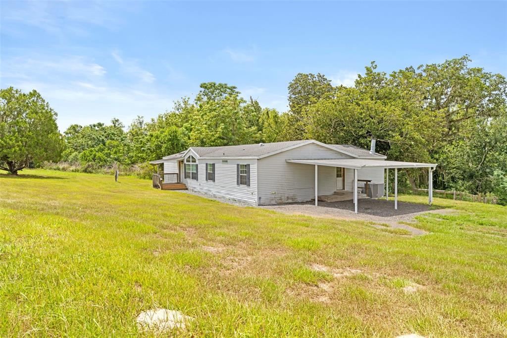 33320 Larkin Road Dade City, FL 33523 - Photo 58 of 60 a front view of a house with a garden