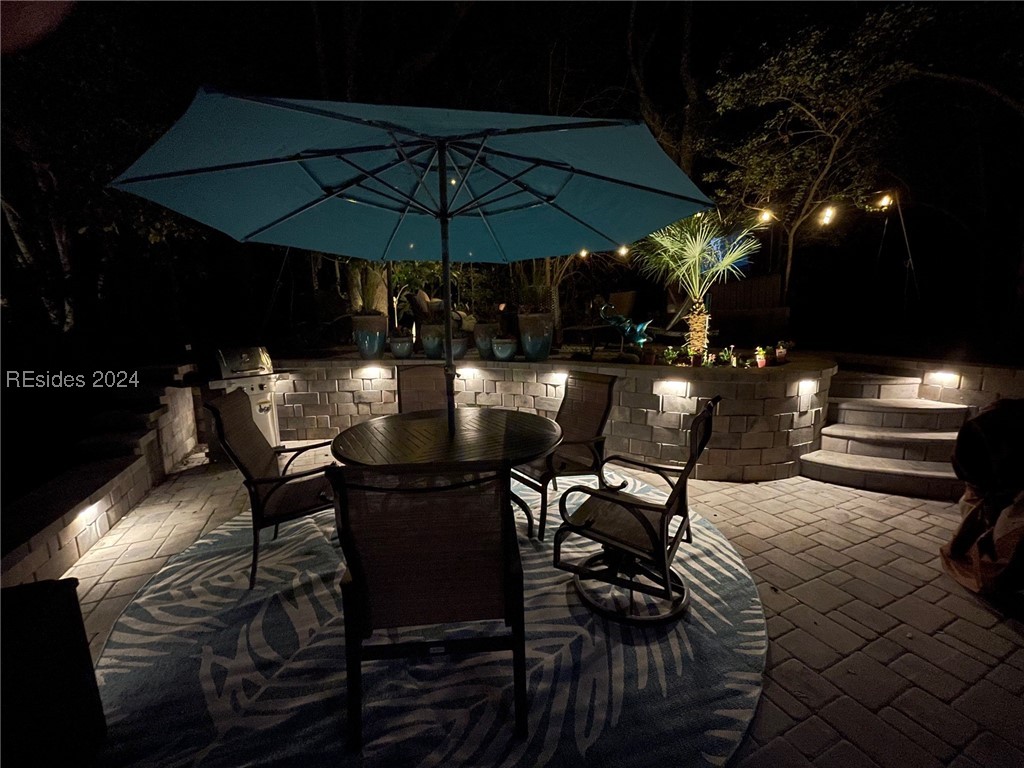 43B Jenkins Island Road Hilton Head Island, SC 29926 - Photo 9 of 19 Patio at night featuring an outdoor kitchen and area for grilling