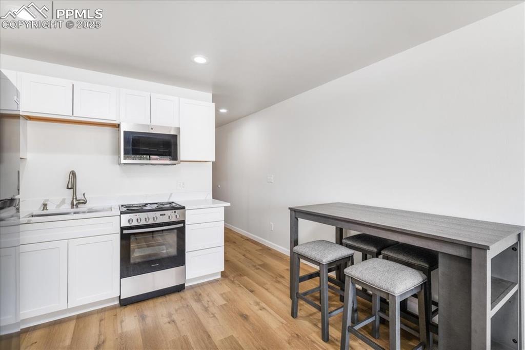 99 Granite Street, Unit 218 Frisco, CO 80443 - Photo 12 of 38 a kitchen with furniture and wooden floor