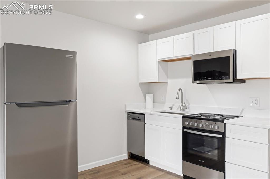 99 Granite Street, Unit 218 Frisco, CO 80443 - Photo 14 of 38 a kitchen with stainless steel appliances a refrigerator stove and microwave