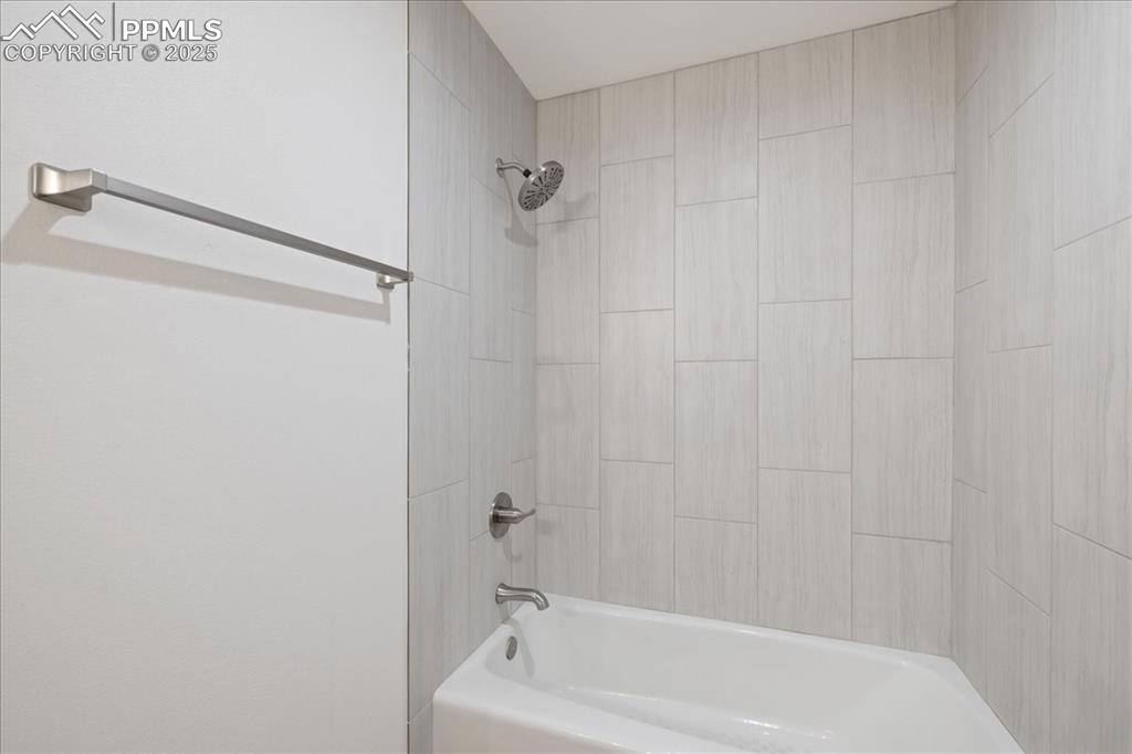 99 Granite Street, Unit 218 Frisco, CO 80443 - Photo 16 of 38 a bathroom with a shower and a bath tub