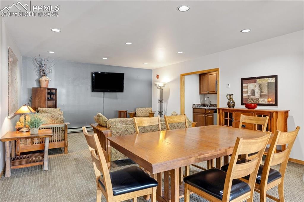 99 Granite Street, Unit 218 Frisco, CO 80443 - Photo 22 of 38 a dining room with furniture a window and a projector