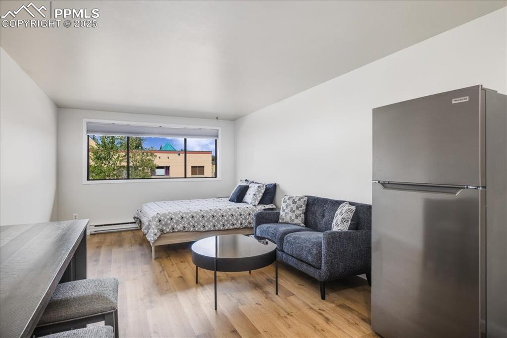 99 Granite Street, Unit 218 Frisco, CO 80443 - Photo 5 of 38 a living room with furniture and a wooden floor