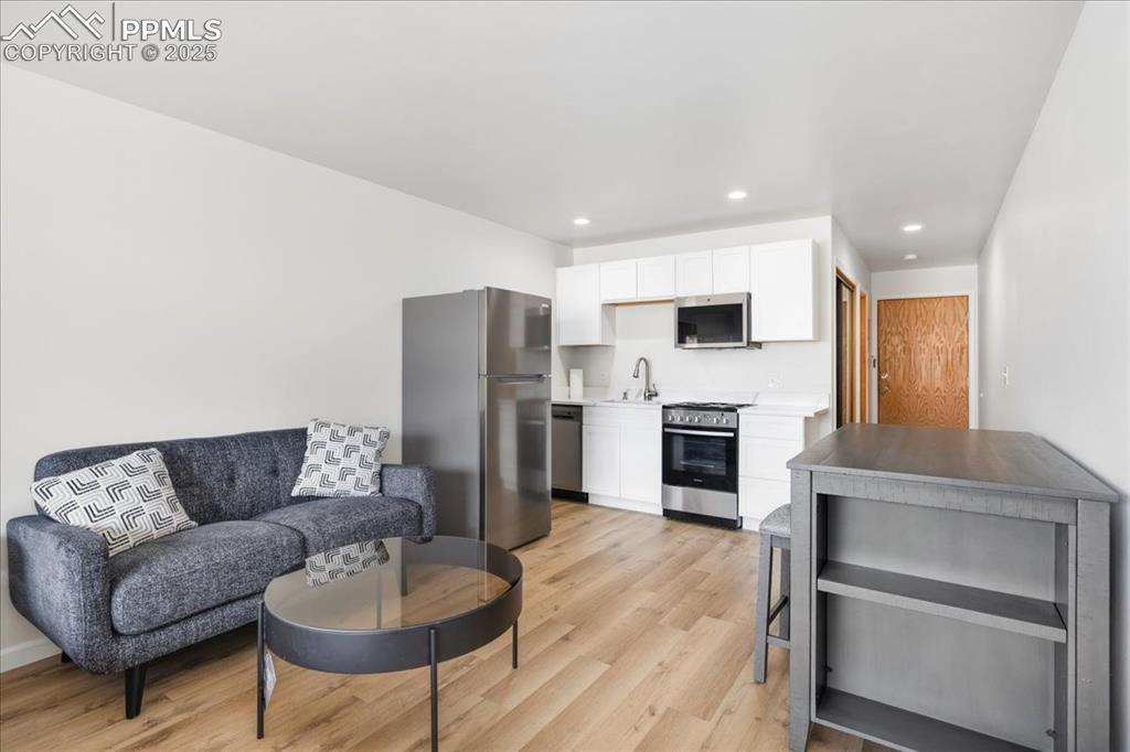 99 Granite Street, Unit 218 Frisco, CO 80443 - Photo 6 of 38 a living room with furniture and a fireplace