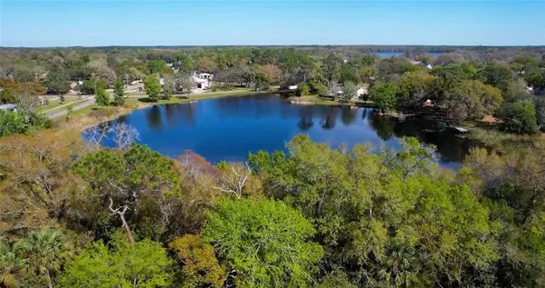 an aerial view of residential houses with outdoor space and swimming pool