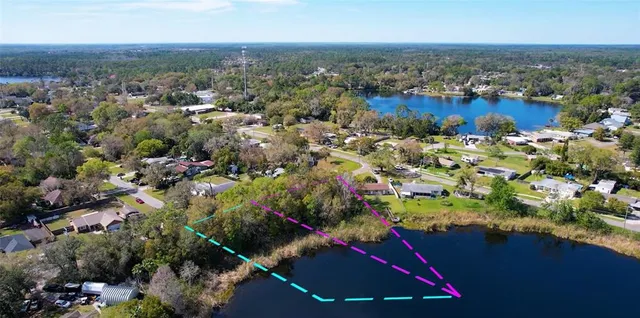 an aerial view of residential houses with outdoor space and swimming pool
