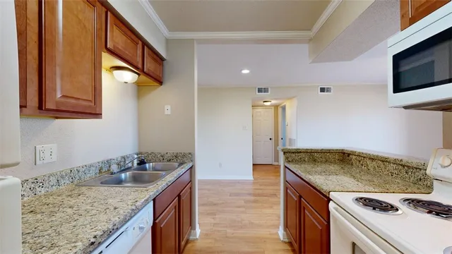 a kitchen that has a sink and a stove