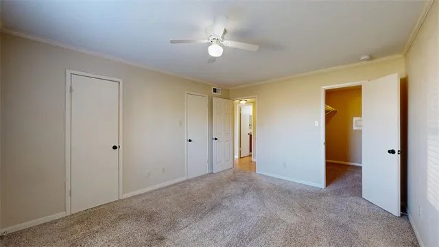 a view of an empty room with a ceiling fan