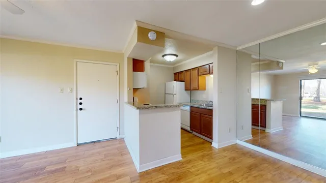 a kitchen with a refrigerator and a stove top oven