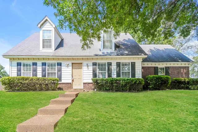 a front view of a house with a yard