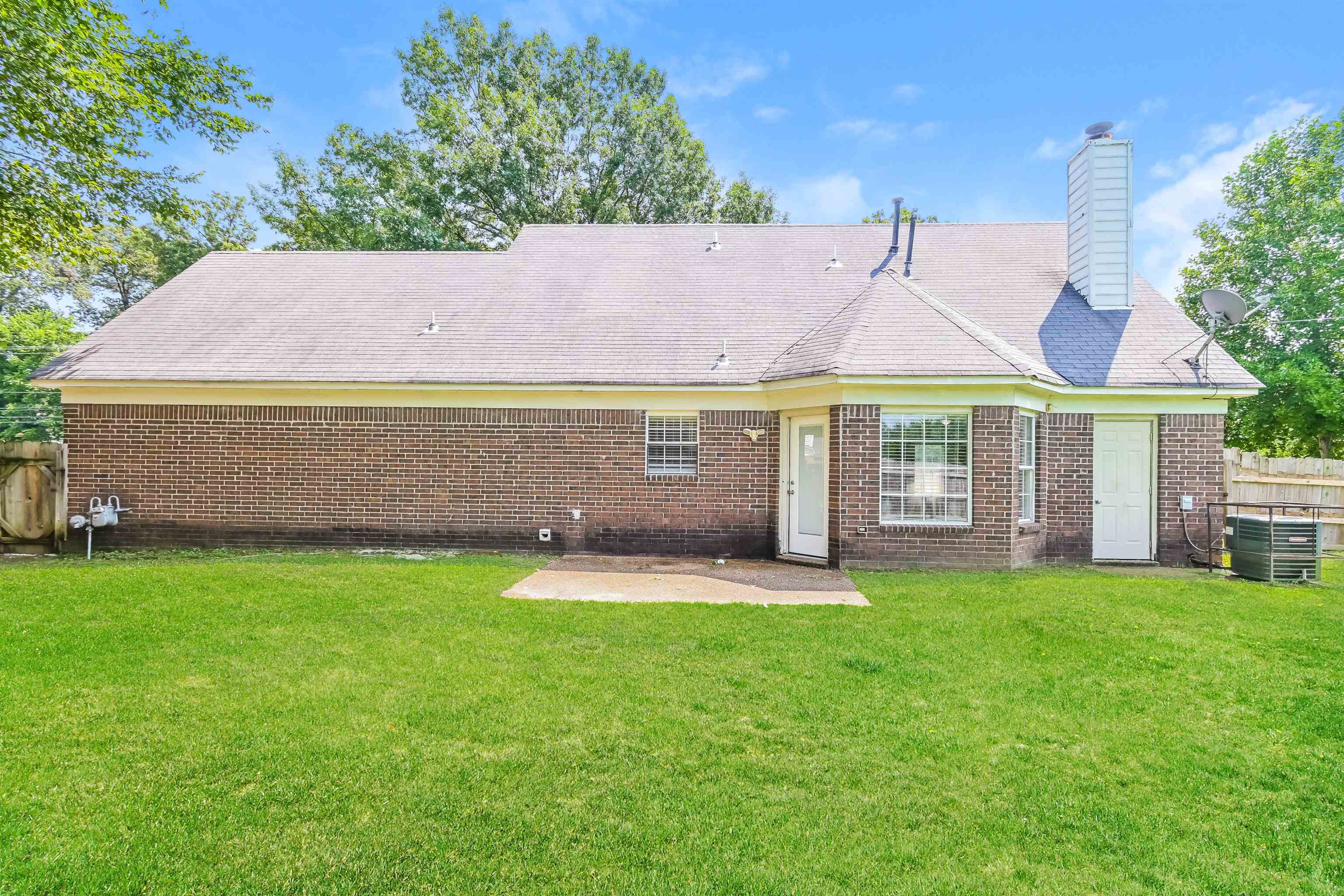 2569 Kate Bond Road Memphis, TN 38133 - Photo 15 of 17 a front view of a house with a yard and trees