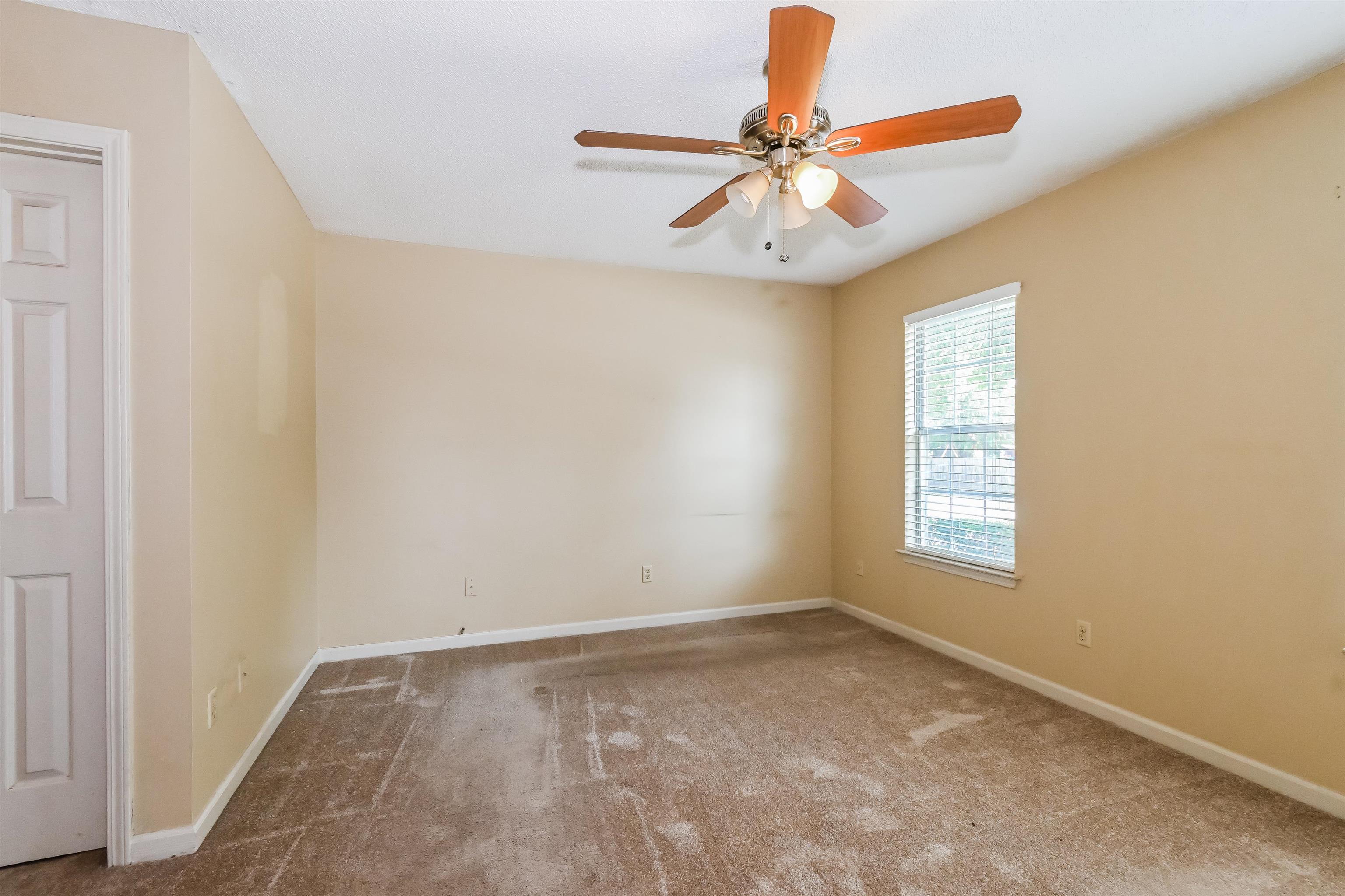 2569 Kate Bond Road Memphis, TN 38133 - Photo 9 of 17 an empty room with windows and fan