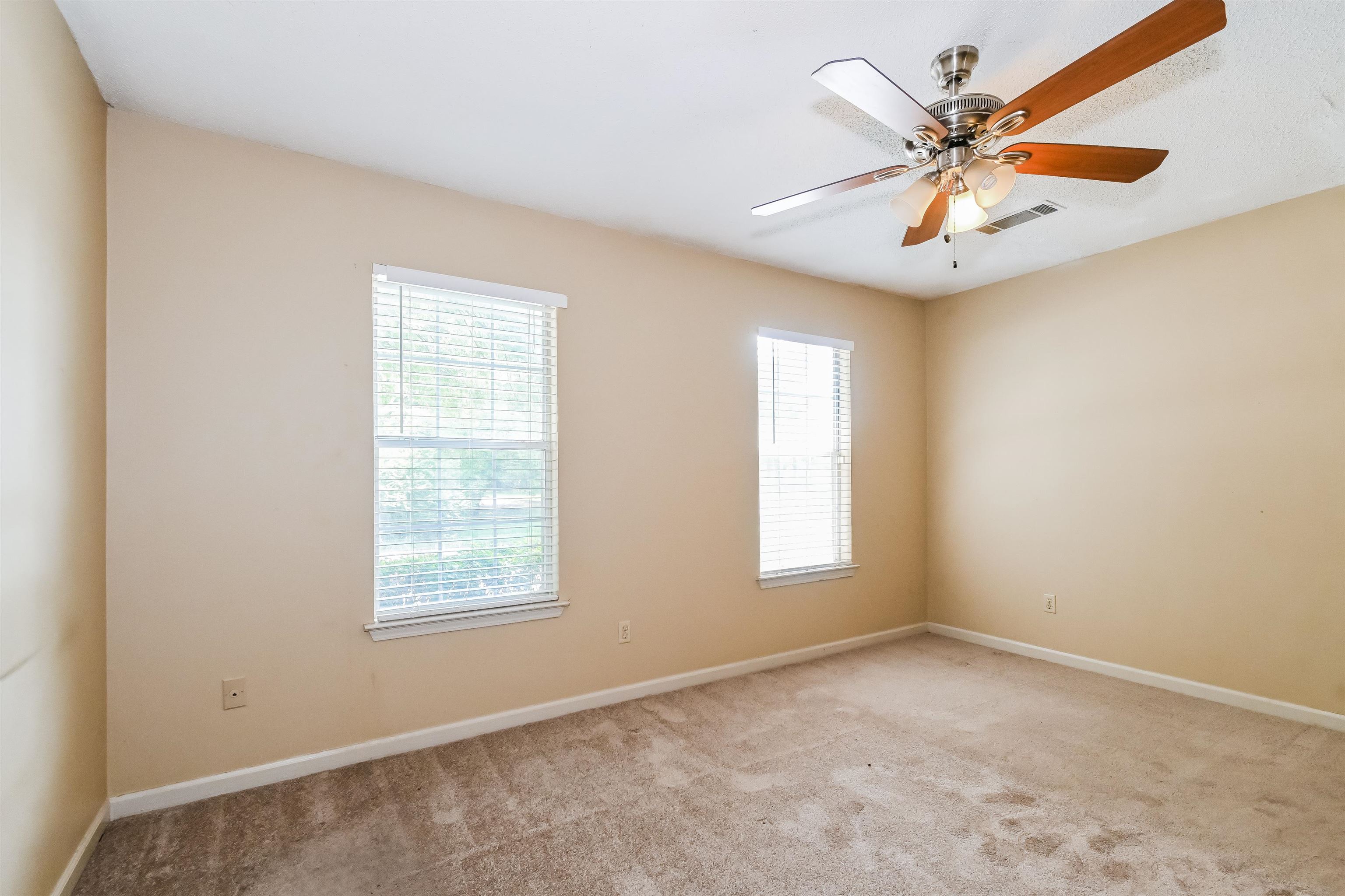 2569 Kate Bond Road Memphis, TN 38133 - Photo 10 of 17 an empty room with windows and fan