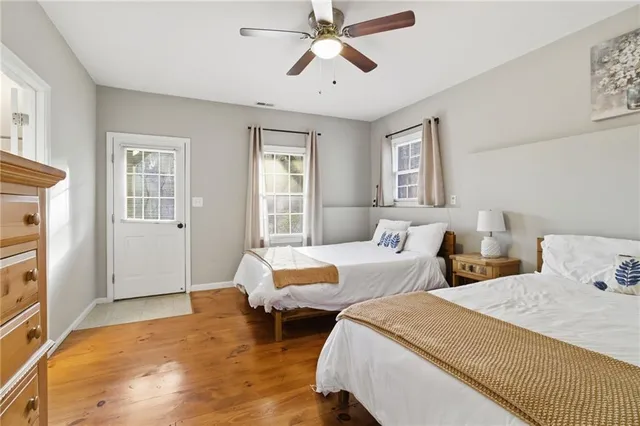 a bedroom with two beds and a chandelier