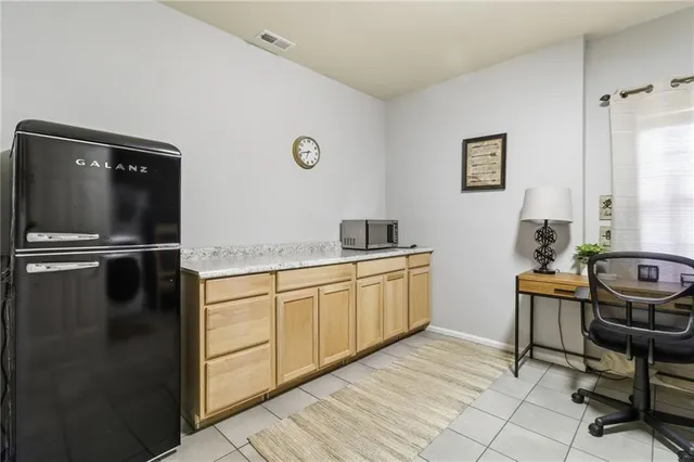 a kitchen with granite countertop a refrigerator and a sink