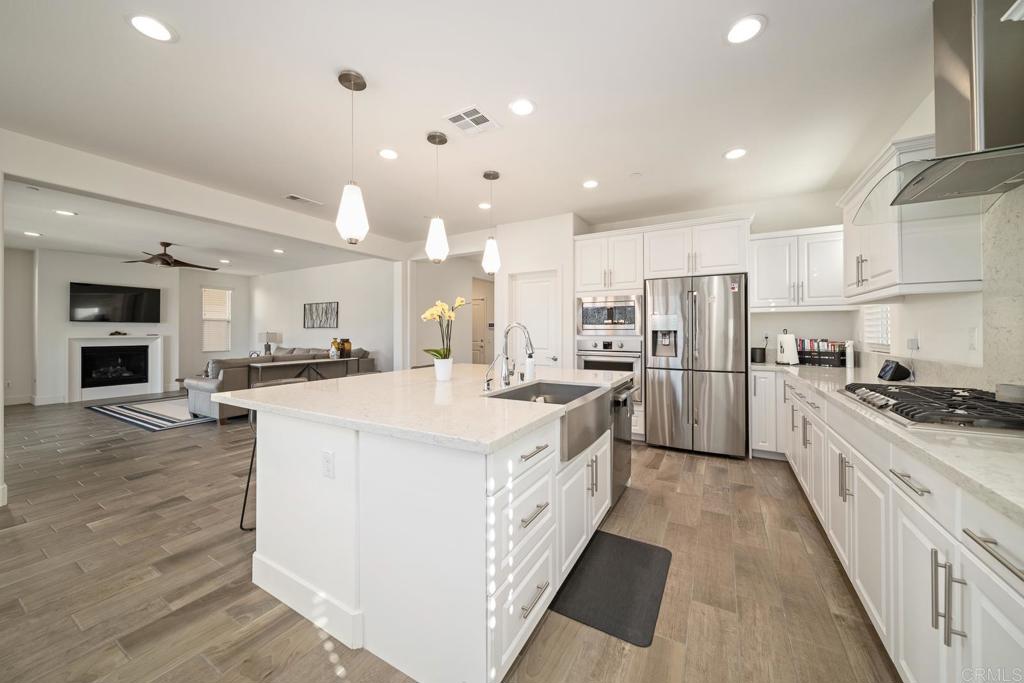 35764 Bay Morgan Lane Fallbrook, CA 92028 - Photo 11 of 69 a large kitchen with stainless steel appliances kitchen island granite countertop a large center island and a stove top oven