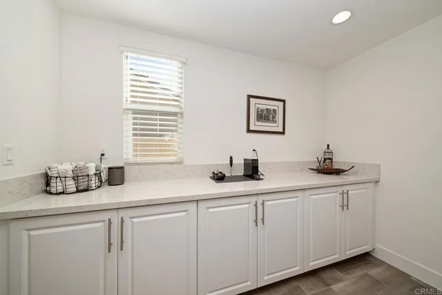 a kitchen with a sink cabinets and wooden floor