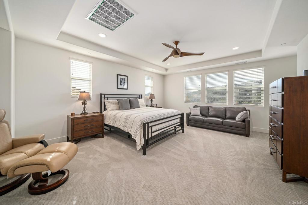 35764 Bay Morgan Lane Fallbrook, CA 92028 - Photo 29 of 69 a spacious bedroom with a bed a couch and large windows