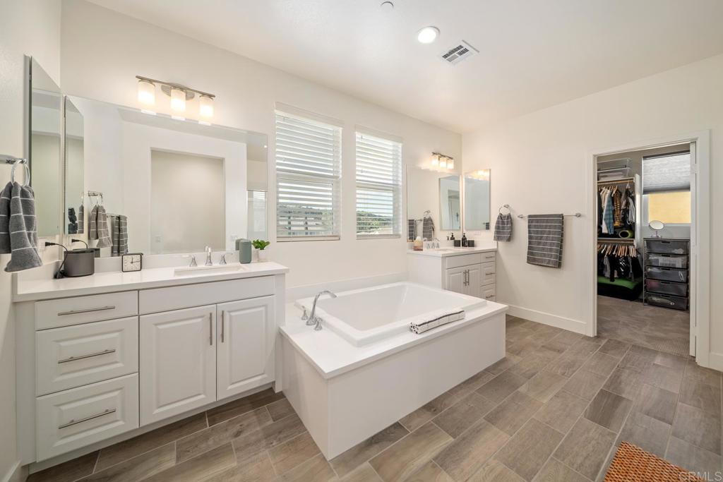 35764 Bay Morgan Lane Fallbrook, CA 92028 - Photo 32 of 69 a spacious bathroom with a double vanity sink a mirror and a bathtub