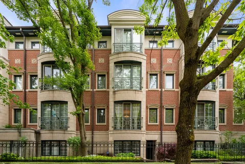 a front view of a residential apartment building with a yard
