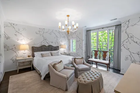 a bedroom with bed and a chandelier
