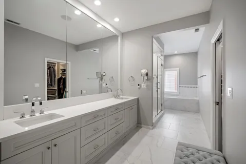 a spacious bathroom with a double vanity sink shower and a mirror