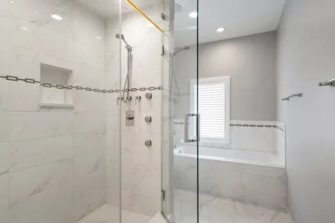 a bathroom with a shower and a glass door