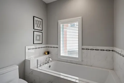 a bathroom with a bathtub and a window