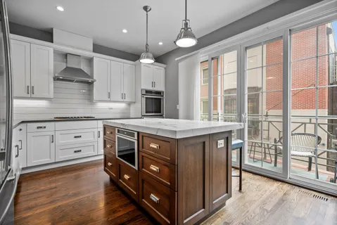 a kitchen with stainless steel appliances granite countertop a stove and a sink
