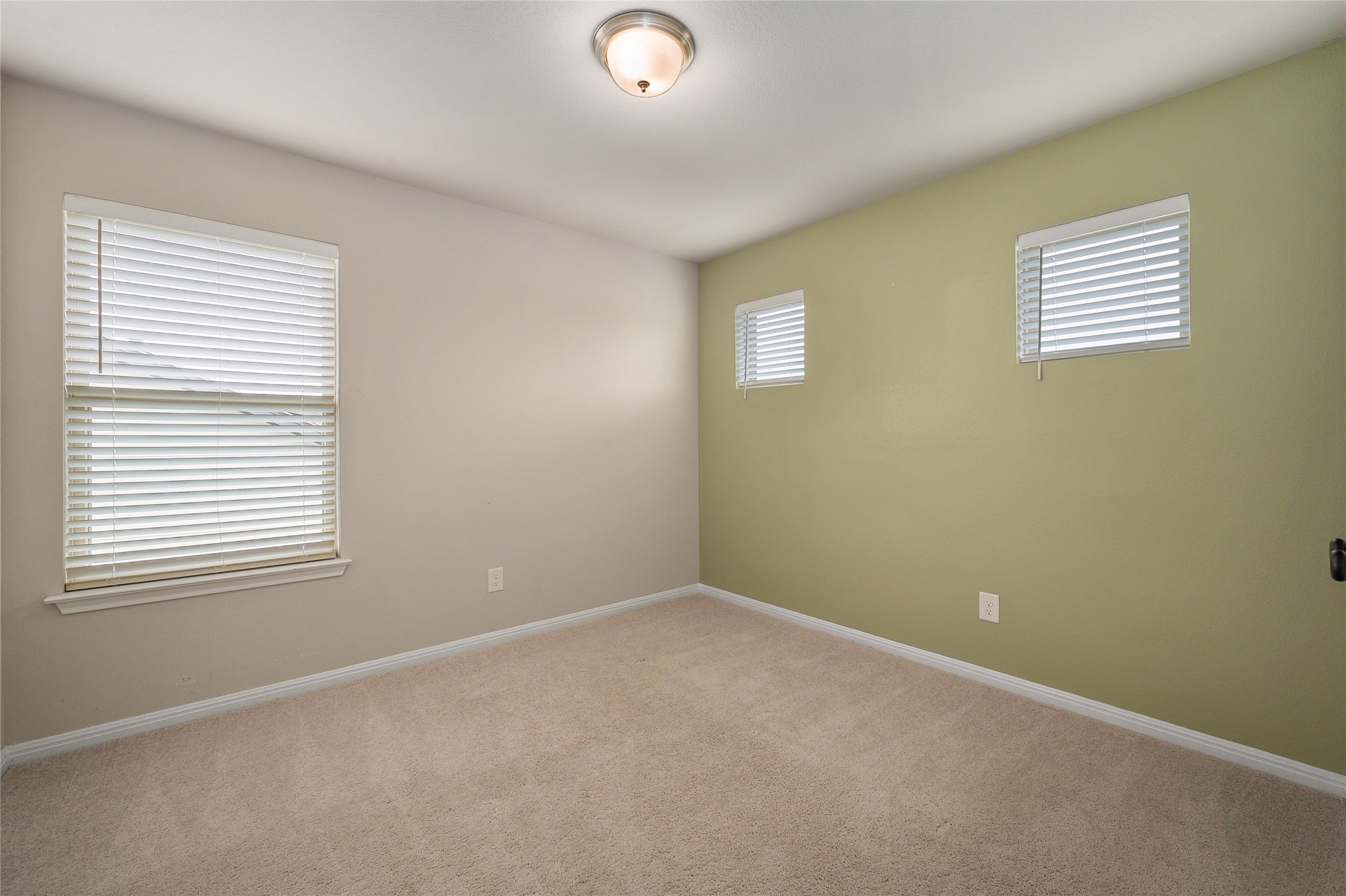 101 Lambert Street Leander, TX 78641 - Photo 22 of 33 A well-lit bedroom offering a neutral palette ready for personalization.