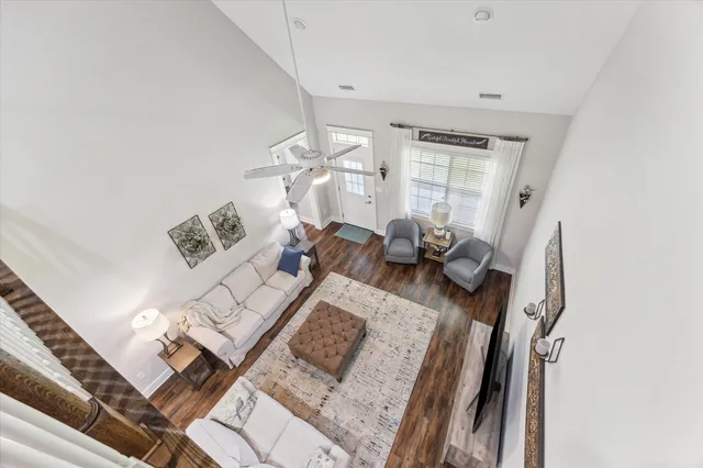 a living room with furniture and wooden floor