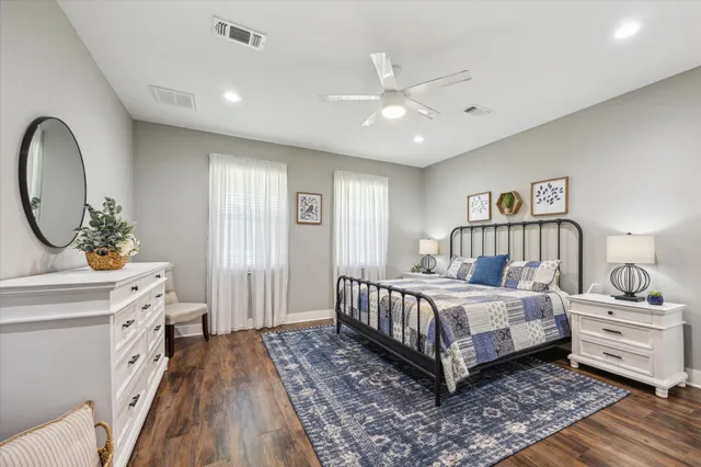 a bedroom with a large bed and a chandelier