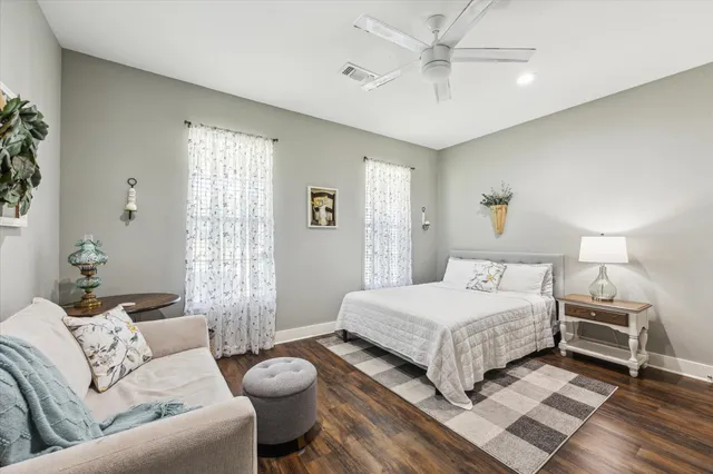 a bedroom with a bed couch and window