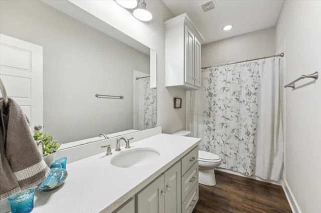 a bathroom with a sink toilet a mirror and shower