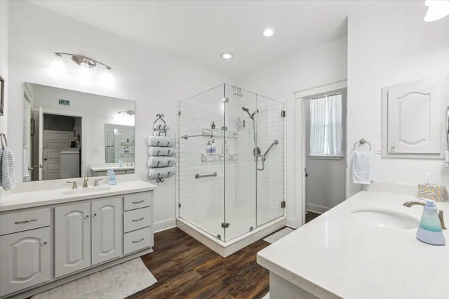 a bathroom with a shower sink and mirror