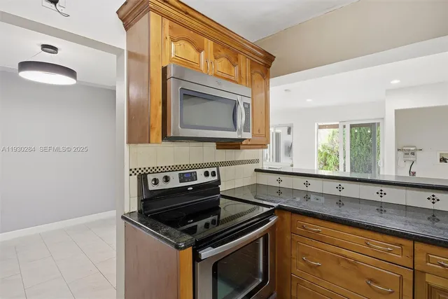 a kitchen with stainless steel appliances granite countertop a sink and cabinets