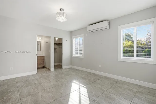 an empty room with closet and a bathroom