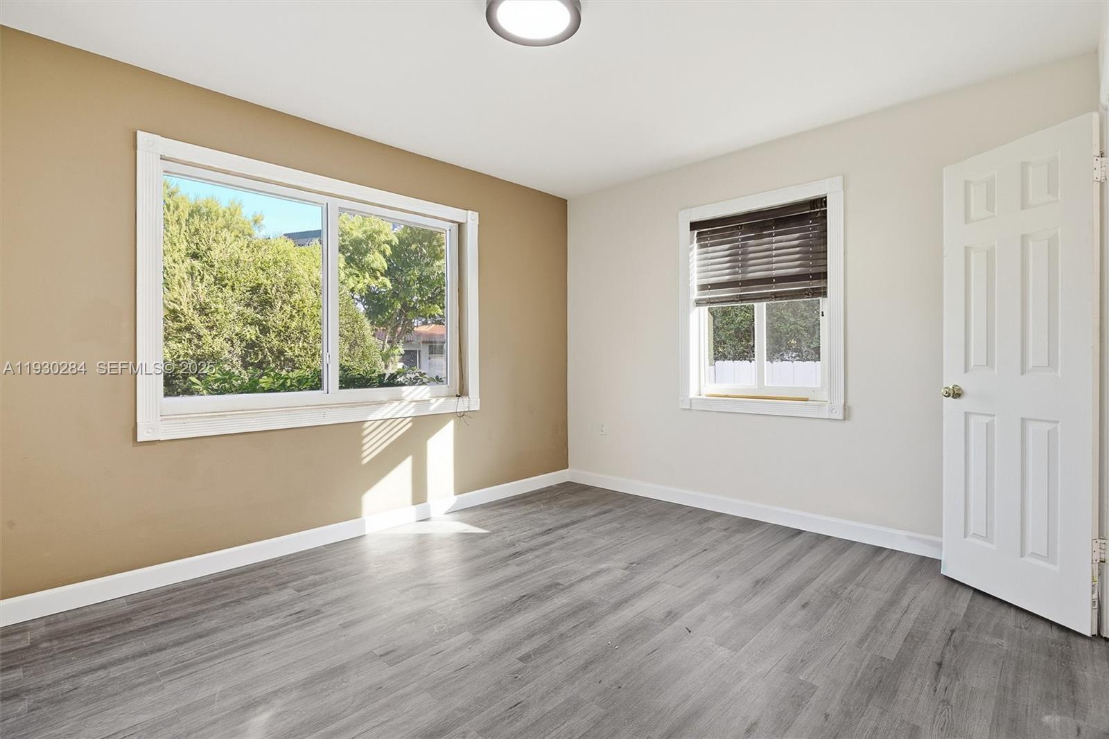 2120 Southwest 16th Street Miami, FL 33145 - Photo 27 of 47 a view of an empty room with wooden floor and a window