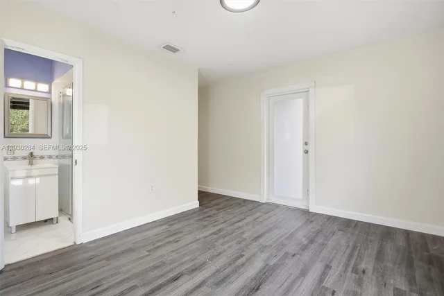 a bathroom with a shower sink and mirror