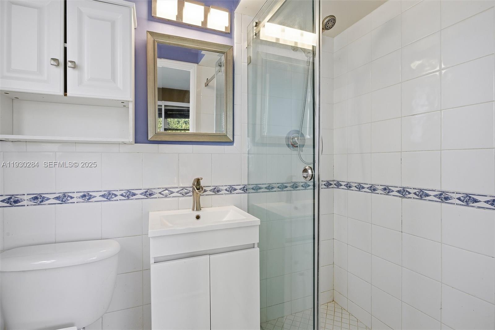 2120 Southwest 16th Street Miami, FL 33145 - Photo 29 of 47 a bathroom with a shower sink and mirror