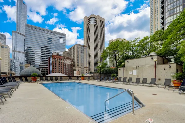 a swimming pool with outdoor seating and yard