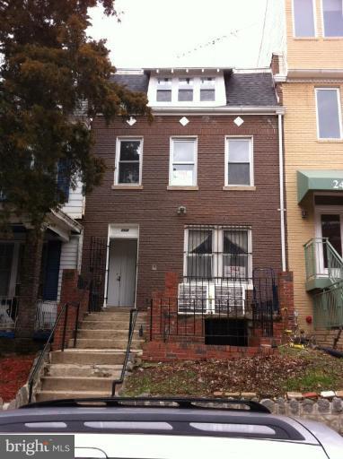 a front view of a house with lots of windows