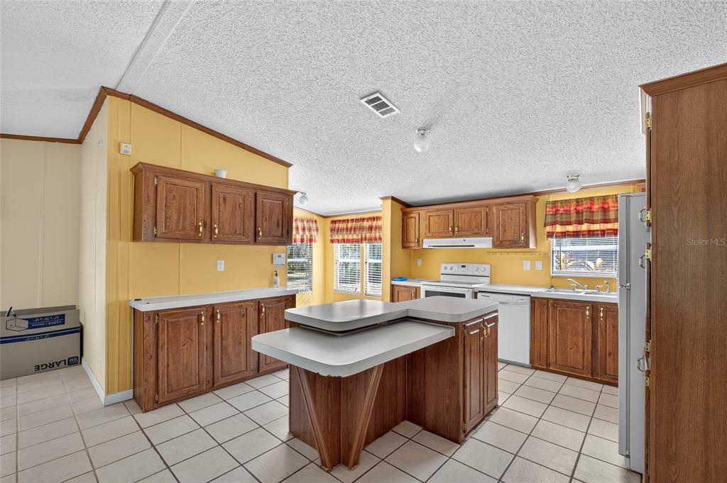 4661 Shepherd Road Lakeland, FL 33811 - Photo 14 of 33 a kitchen with kitchen island granite countertop a sink counter top space and appliances