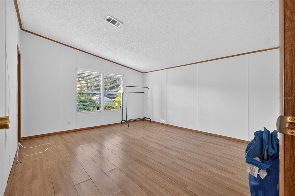 4661 Shepherd Road Lakeland, FL 33811 - Photo 29 of 33 a view of an empty room with wooden floor and a window