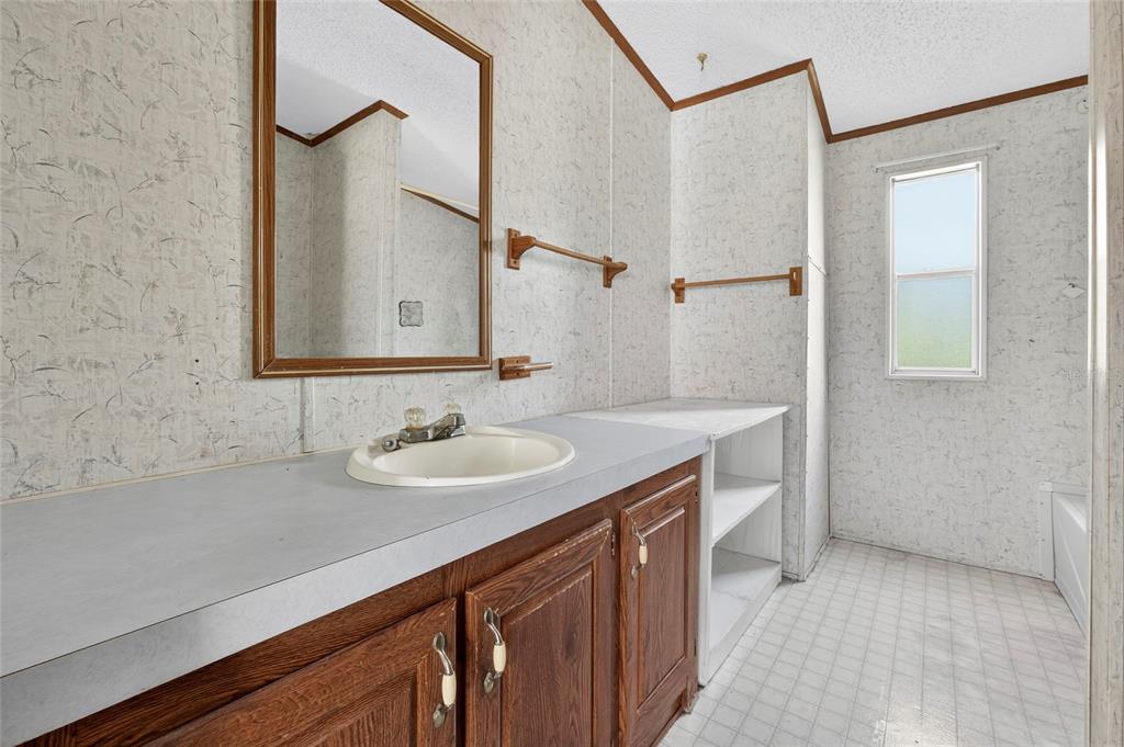 4661 Shepherd Road Lakeland, FL 33811 - Photo 30 of 33 a bathroom with a sink and a mirror