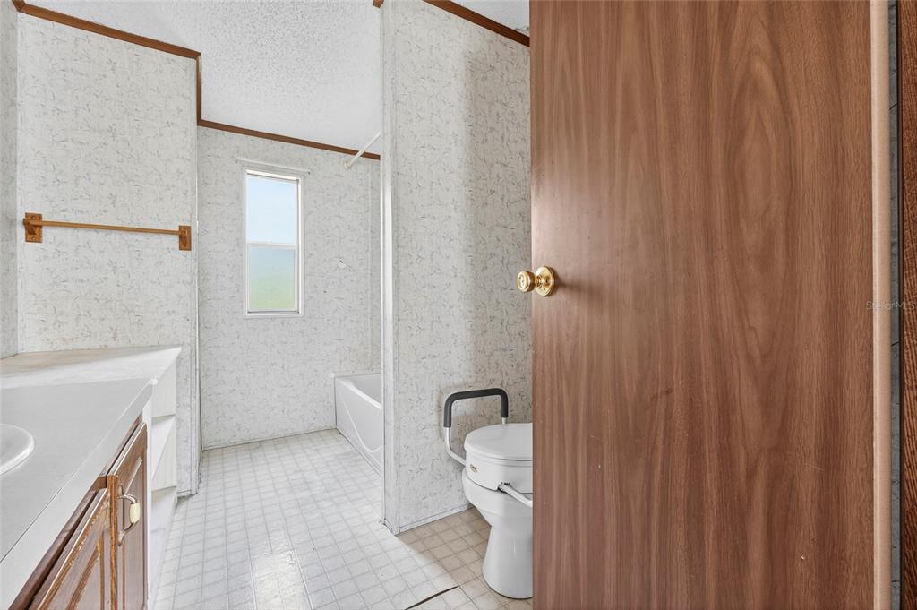 4661 Shepherd Road Lakeland, FL 33811 - Photo 31 of 33 a bathroom with a sink a toilet and shower