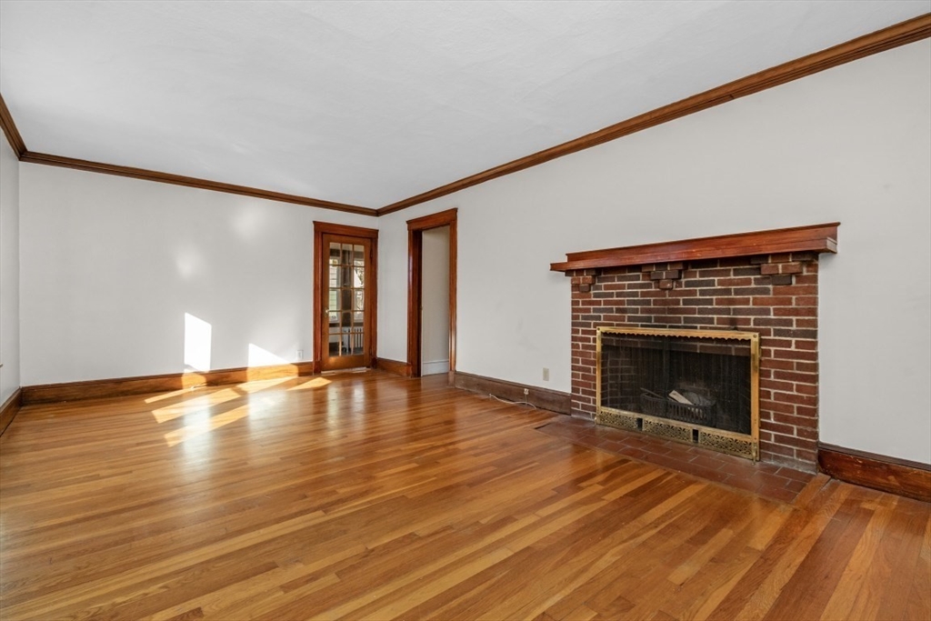 41 Whittemore Road, Unit 1 Newton, MA 02458 - Photo 4 of 18 a view of empty room with wooden floor and fireplace