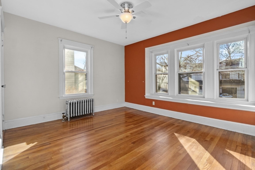 41 Whittemore Road, Unit 1 Newton, MA 02458 - Photo 8 of 18 a view of an empty room with a window and wooden floor