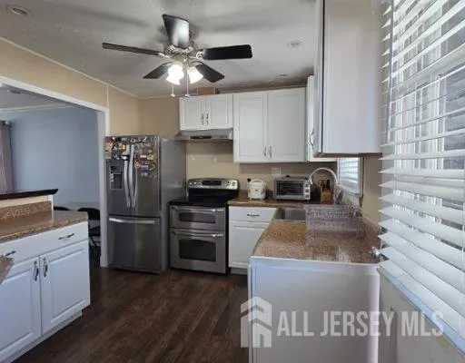 a kitchen with a refrigerator and a sink